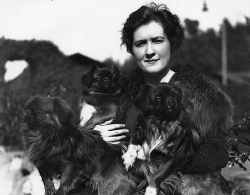 Woman and her pekingese dogs