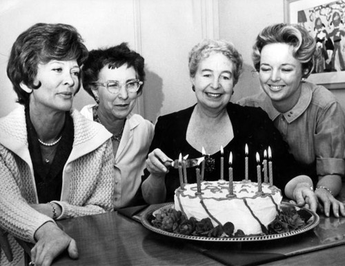 Colfax principal, Mrs. Frances Pfortner, cuts birthday cake