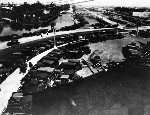 Automobiles parked along the canal