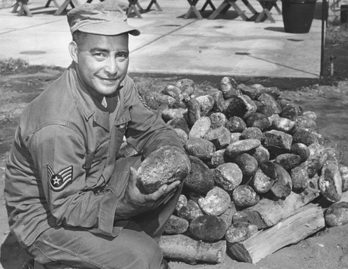 Sgt. Ed Apo checks over imported volcanic rocks