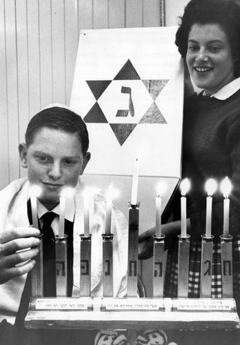 Children light holiday candles