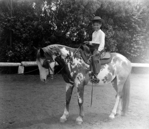 Unidentified young girls ride horseback