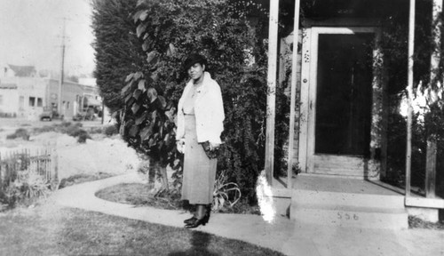 Woman in front of family home