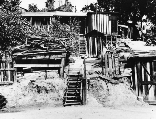 Exterior view of a slum dwelling, Fickett Hollow