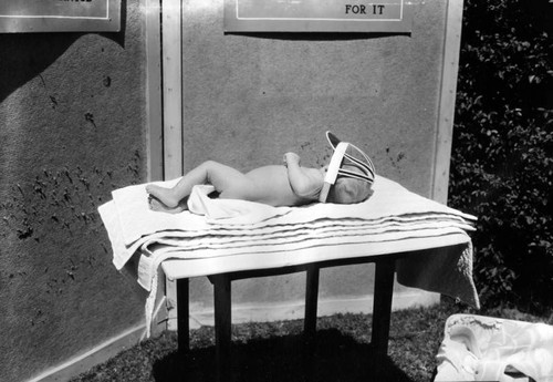 Child lying on table