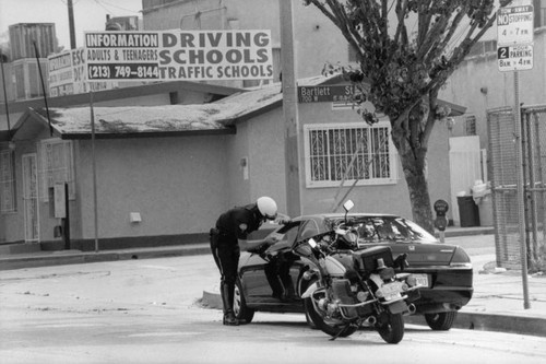 Motorcycle policeman giving citation