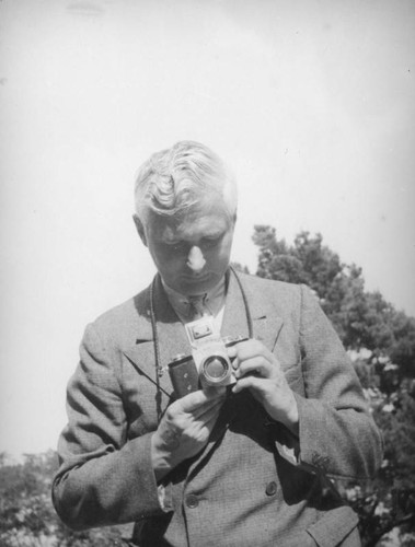 Herman Schultheis checks his camera, Chico