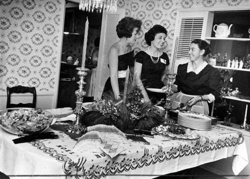 Tossed green salad, lasagne, hot hors d'oeuvres cover holiday decorated table in Hicks home