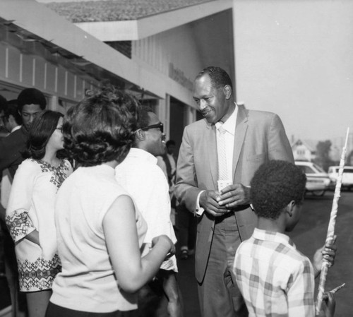 Tom Bradley greets a crowd of supporters