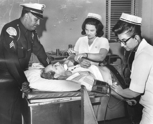 Nurses work on injured man