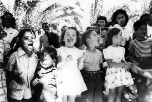 Children bobbing for apples