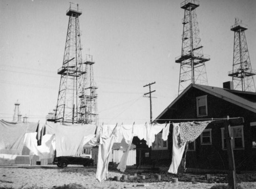 Oil derricks behind houses in Venice