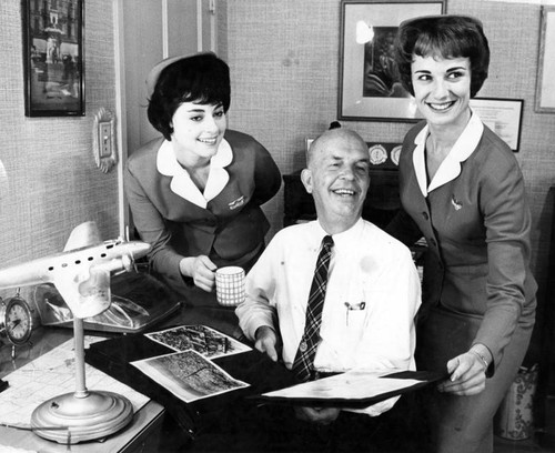 Coffee, tea or milk? Kathy LaBelle offers a cup to "Father of Stewardesses"