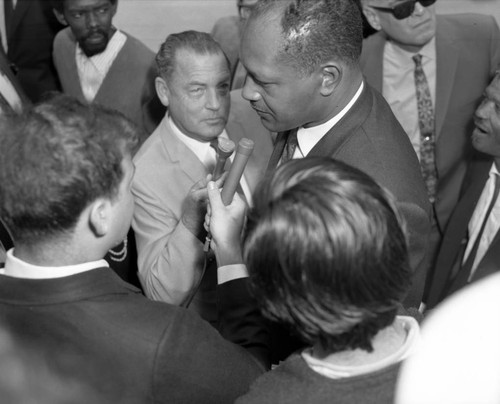 Councilman Tom Bradley surrounded by reporters