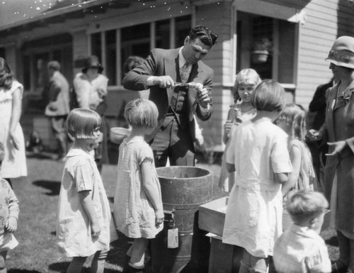 Dempsey with children, view 1