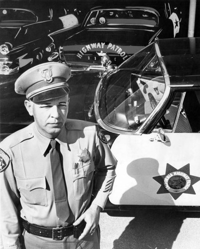 Officer M. W. Forinash of Newhall Station, with CHP car