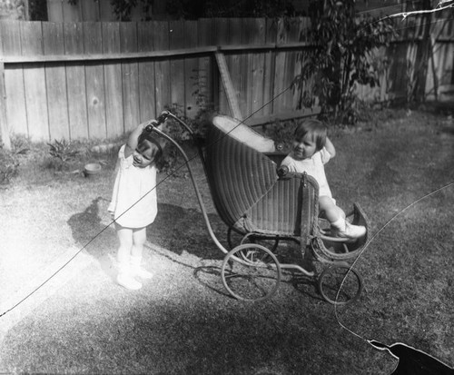 Twins playing with buggy