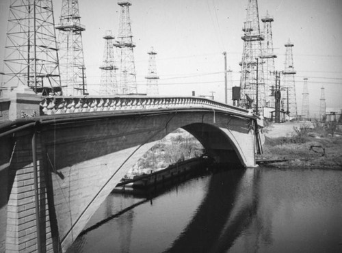 Bridge crossing Ballona Creek surrounded by oil wells