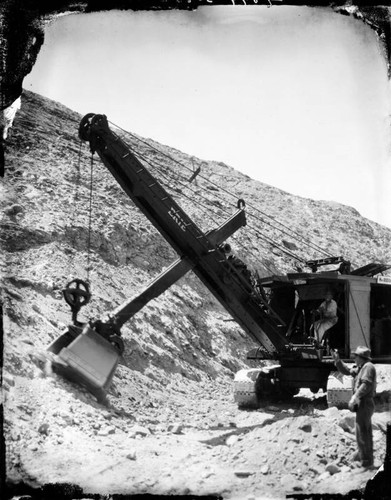 Two workmen with large shovel