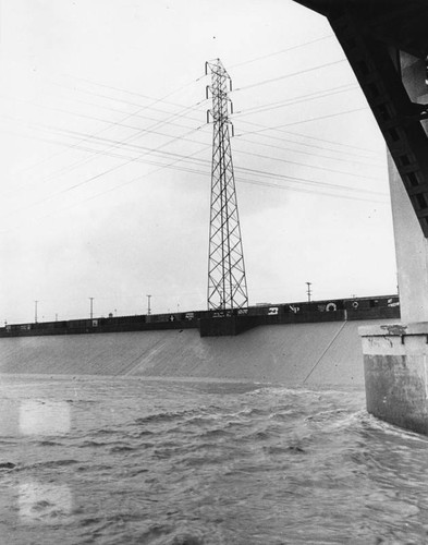 Rough waters flow under bridge