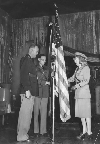 Marion Davies presents the colors to the Guard