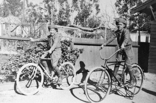 Boys in berets on bikes