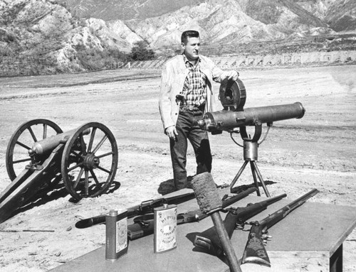 Inspects working Gatling gun at close range