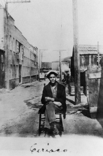 Mexican American man sitting in alley