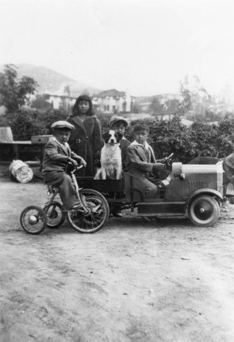 Children with a toy car