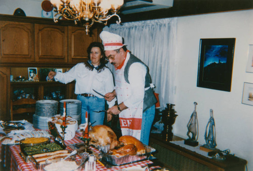 Father carves turkey for a Thanksgiving celebration