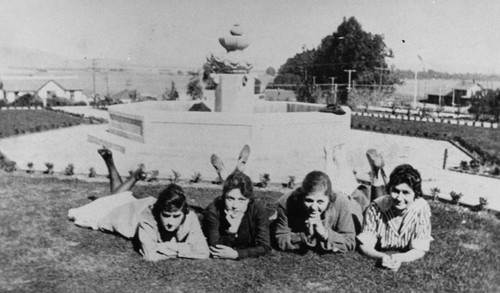 Four women posing at the park