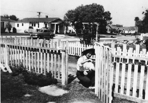 Japanese American woman painting fence