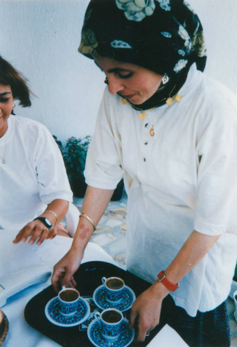 Turkish woman serves coffee