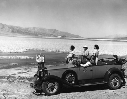 Tourists viewing Badwater in Death Valley from their car