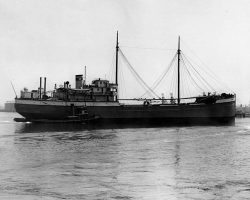 Ship escorted by a tug