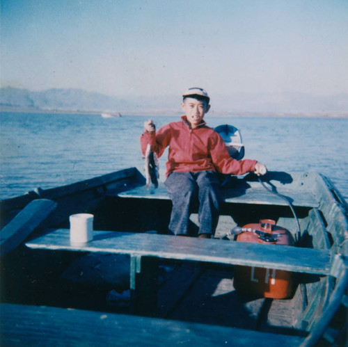 Young boy boat fishing