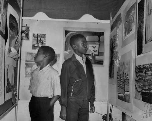 Young boys look at exhibits, Watts