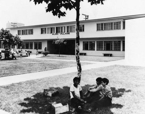 Children playing outside their apartments, Aliso