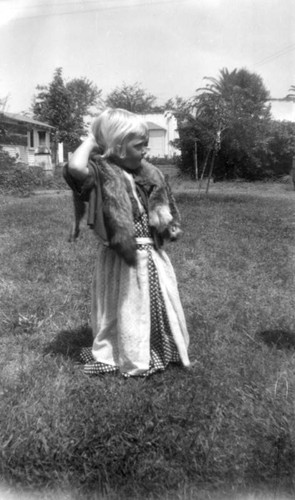 Girl in long dress on lawn