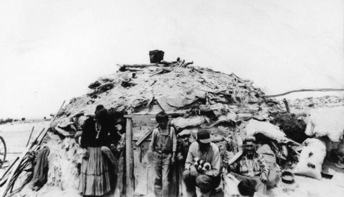 Navajo Indian family outside of hogan