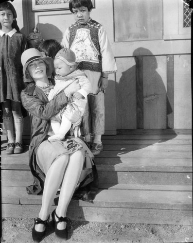 Young woman holding a Chinese baby