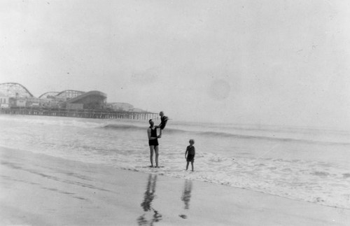 Man with two children on the beach