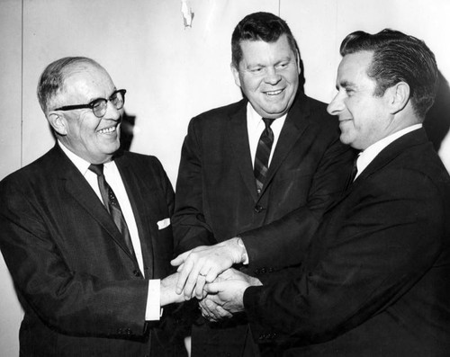 The Rev. Bernard Hertel, right, is congratulated by county supervisor