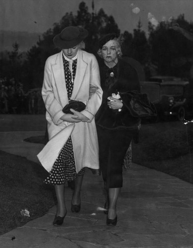 Two of the people attending Thelma Todd's funeral: Mrs. Wallace Ford (on the left) and Josie Sedgewicke. Mrs. Ford reported she received a telephone call from Miss Todd Sunday afternoon. Officers had believe she died early Sunday morning.