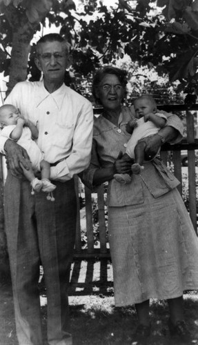 Grandparents holding twins