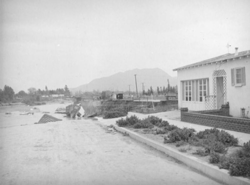 L.A. River flooding, intact house and destroyed house in North Hollywood