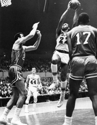 Lakers' Elgin Baylor goes in to score two points