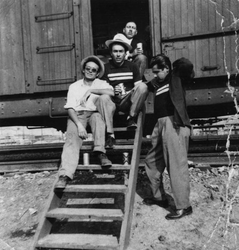 Mexican Americans on steps to boxcar