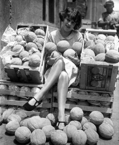 Woman with cantaloupes