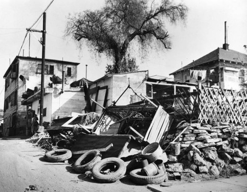 Trash and old tires in front of slum dwelling